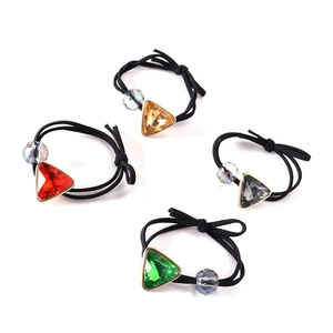 Set of 4 elastic hair bands with faceted triangular gems in red, green, yellow, and grey