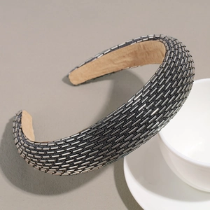 Detailed side view of baroque padded headband featuring silver metallic tube beadwork