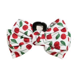 Elegant hair claw clip with large fabric bow featuring vibrant red cherry print pattern