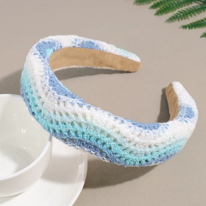 Detailed close-up of blue knitted bohemian headband with soft light brown inner lining