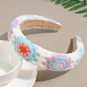 Detailed macro view of bohemian crochet knit headband with colorful floral patterns