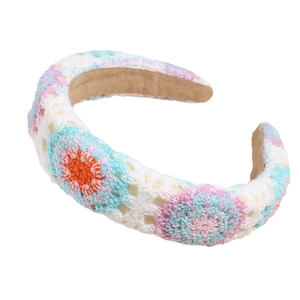 Handmade knitted floral headband with white, blue and pink yarn in bohemian garden style