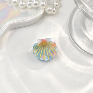 Macro detail of mini shell hair clip with blue pink marble texture and gold lines