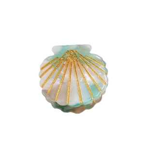 Elegant shell-shaped acetic acid hair clip with mint green marble texture and gold glitter