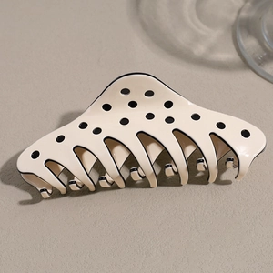 Polka dot hair claw clip with cream base and smooth resin finish for elegant styling