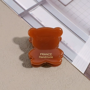 Detail of bear hair clip with France Handmade gold lettering on amber acetate