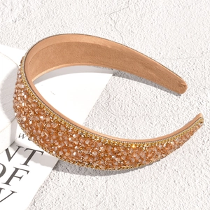Close-up of champagne crystal beaded wide headband with gold rhinestones and soft inner lining