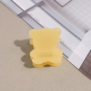 Detail of cute yellow bear hair claw showing the France Handmade engraving on resin