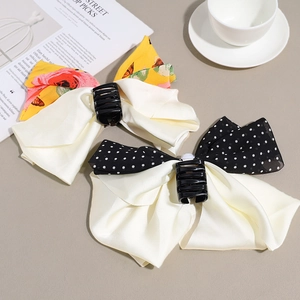 Elegant satin bow hair claws with floral and polka dot patterns for high ponytail styles