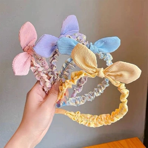 Close-up of four floral pleated headbands with cute rabbit ear bow knots in candy colors