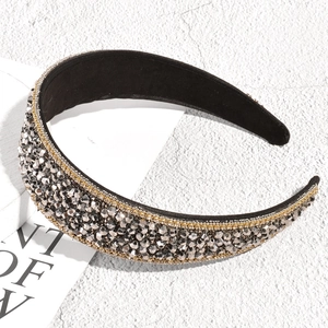 Detail showing hand-sewn grey crystal beads and golden chain on a wide velvet headband