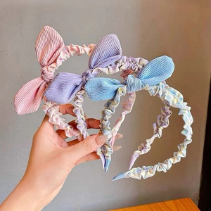 Three-piece set of sweet bow headbands in pink, purple, and blue floral corduroy