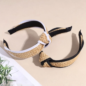 Fashionable straw braided knot headbands in black and white trim for a minimalist summer look