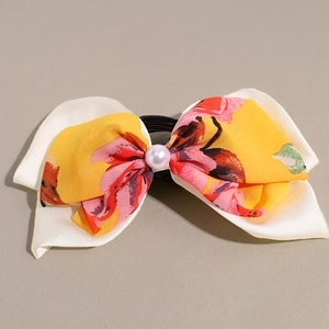 Minimalist double-layer floral bow hair tie with a central pearl and floral patterns