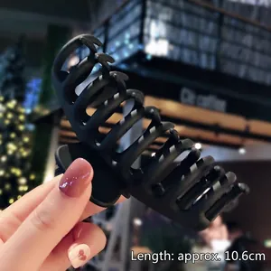 Detail view of 10.6cm matte black acrylic shark hair claw clip for thick hair