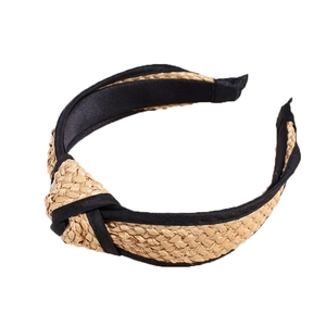 Bohemian style straw knot headband with black fabric lining on a clean white background