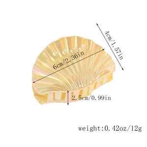 Detail view of shell-shaped hair claw with dimensions 6x4cm and 12g weight specs
