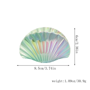 Macro detail of shell hair claw clip showing iridescent pearl finish and 9.5cm dimensions