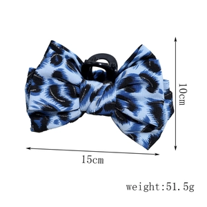 Detail view of leopard print bow hair claw clip with size dimensions 15cm and 10cm