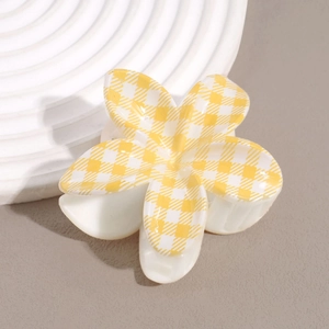 Detailed side view of yellow gingham flower hair claw clip with sturdy metal spring