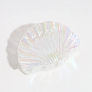 Macro view of shell shaped iridescent laser hair claw with pearlescent acrylic finish