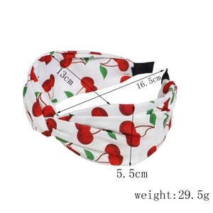 Detail view of cherry print headband with 13cm diameter and 29.5g weight specifications