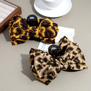 Set of two stylish leopard print bow hair claws with classic yellow and light coffee patterns