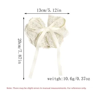 Detailed size and weight view of a cream lace bow hair clip with embroidery and long ribbons