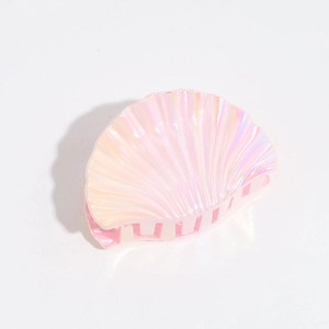 Close-up of shell shaped hair claw clip with iridescent pearlescent finish and gradient pink tones