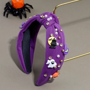 Detail of purple knotted Halloween headband with pumpkin, ghost, pearls and rhinestones