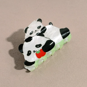 Détail de la pince à cheveux panda en acétate perlé avec base verte transparente