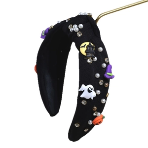 Halloween knot headband featuring orange pumpkins, white ghosts, and festive pearls