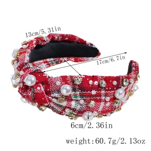 Detail of red plaid knotted headband with faux pearls and sparkling rhinestones