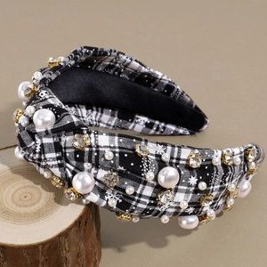 Plaid knotted headband with white pearls and rhinestones on a rustic wood background