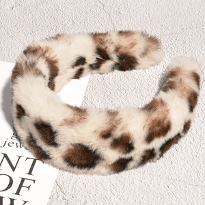 Detailed view of the soft leopard print plush headband texture and winter fabric material