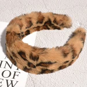 Macro detail of plush faux fur texture and leopard pattern on wide autumn hairband