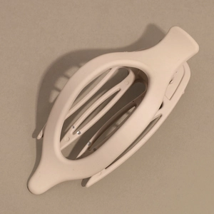 Macro detail of the matte beige finish and inner teeth of the large minimalist hair claw