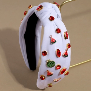Close-up of white fabric headband with sparkling red rhinestones and watermelon charms