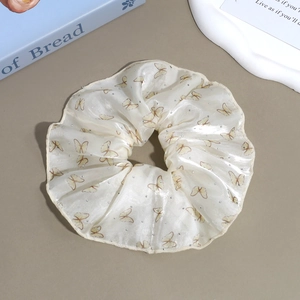 Detail of floral organza scrunchie with yellow butterfly prints and subtle rhinestones