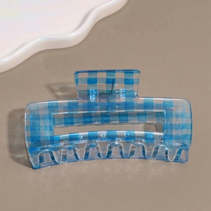 Close-up of blue gingham rectangular hair claw clip with transparent resin finish