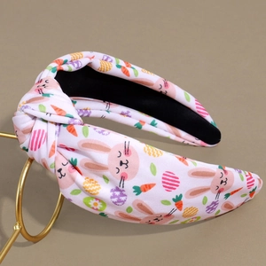 Close-up of Easter knot headband with printed rabbit, carrot and colorful egg patterns
