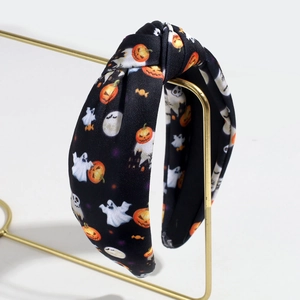Halloween knot headband with orange pumpkin and white ghost patterns on black fabric