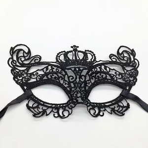 Detail of black lace fox mask with crown design and intricate arabesque patterns