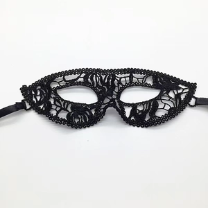 Detailed macro shot of black lace fox mask with intricate cutout patterns for Halloween decor