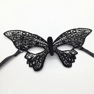 Detailed view of intricate black lace butterfly mask with satin ties for masquerade
