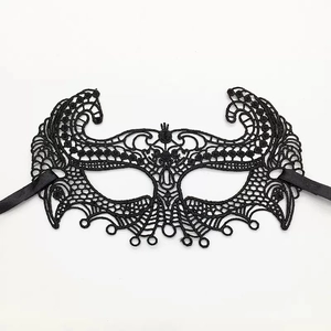 Detailed close-up of Gothic black lace fox mask with intricate embroidery and satin ribbons