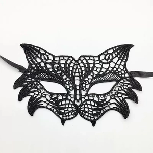 Close-up of black lace fox mask with intricate embroidery for Halloween cosplay