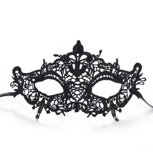 Detailed close-up of Gothic black lace fox mask with intricate cutout patterns and silk ribbons
