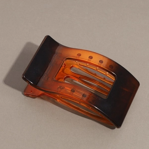 Detailed view of large leopard print hair claw clip with smooth resin finish