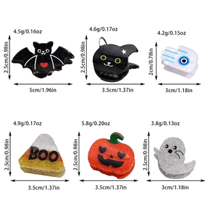 Detailed view of Halloween hair clips featuring bat and ghost designs with size measurements